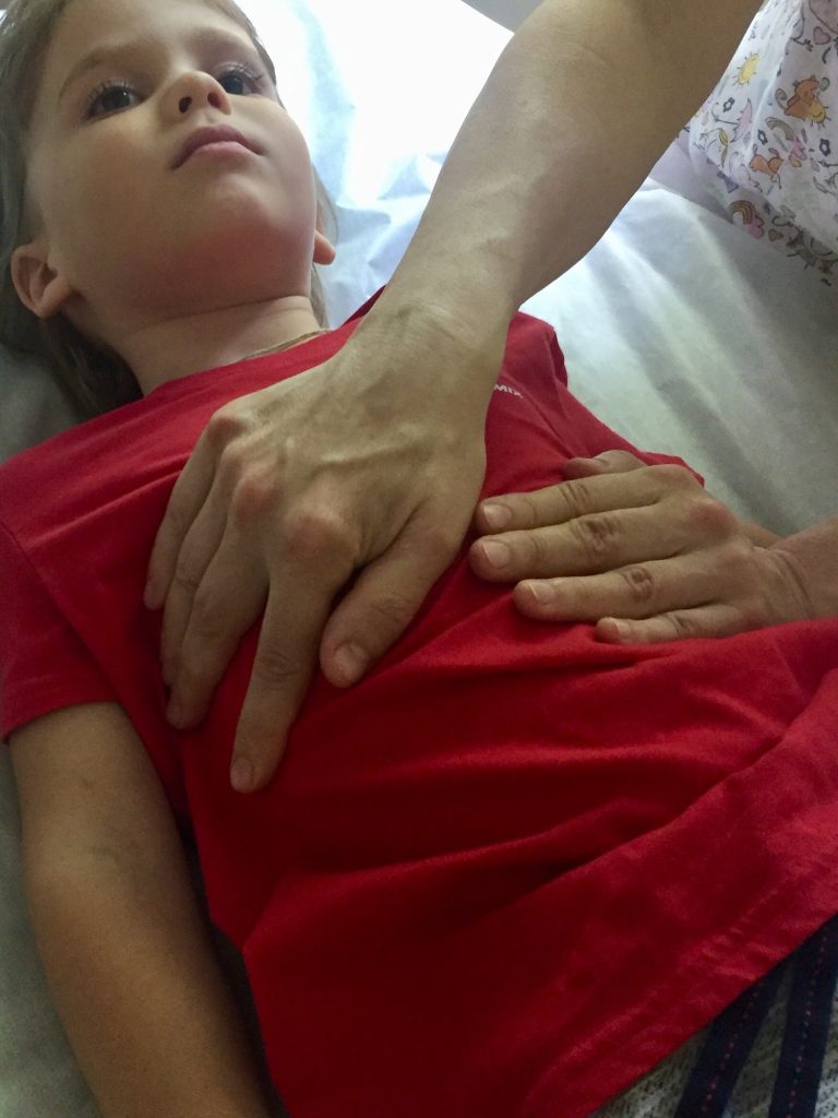 osteopathy session. alternative medicine. an osteopathic physician doctor treats a little kid boy